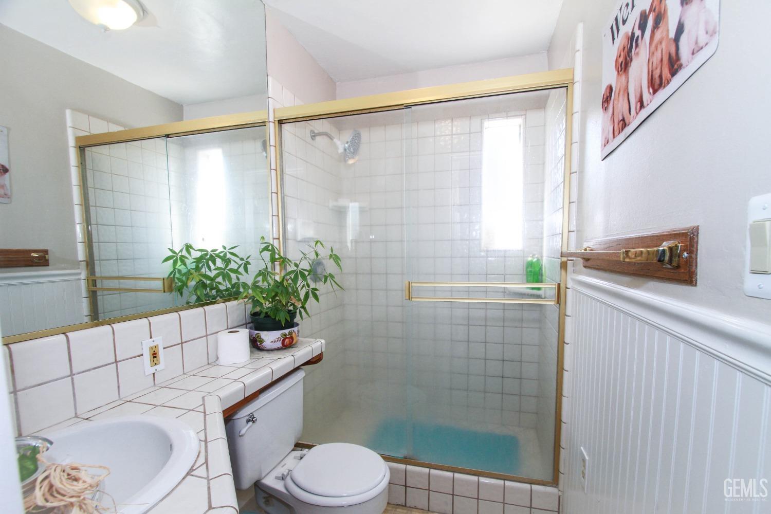 Undisclosed Address Bakersfield, CA 93309 - Photo 17 of 19 a bathroom with a toilet a sink and shower