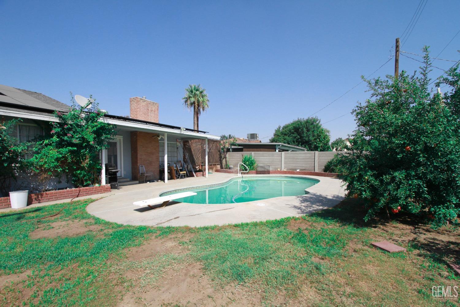 Undisclosed Address Bakersfield, CA 93309 - Photo 18 of 19 a front view of a house with a yard and potted plants