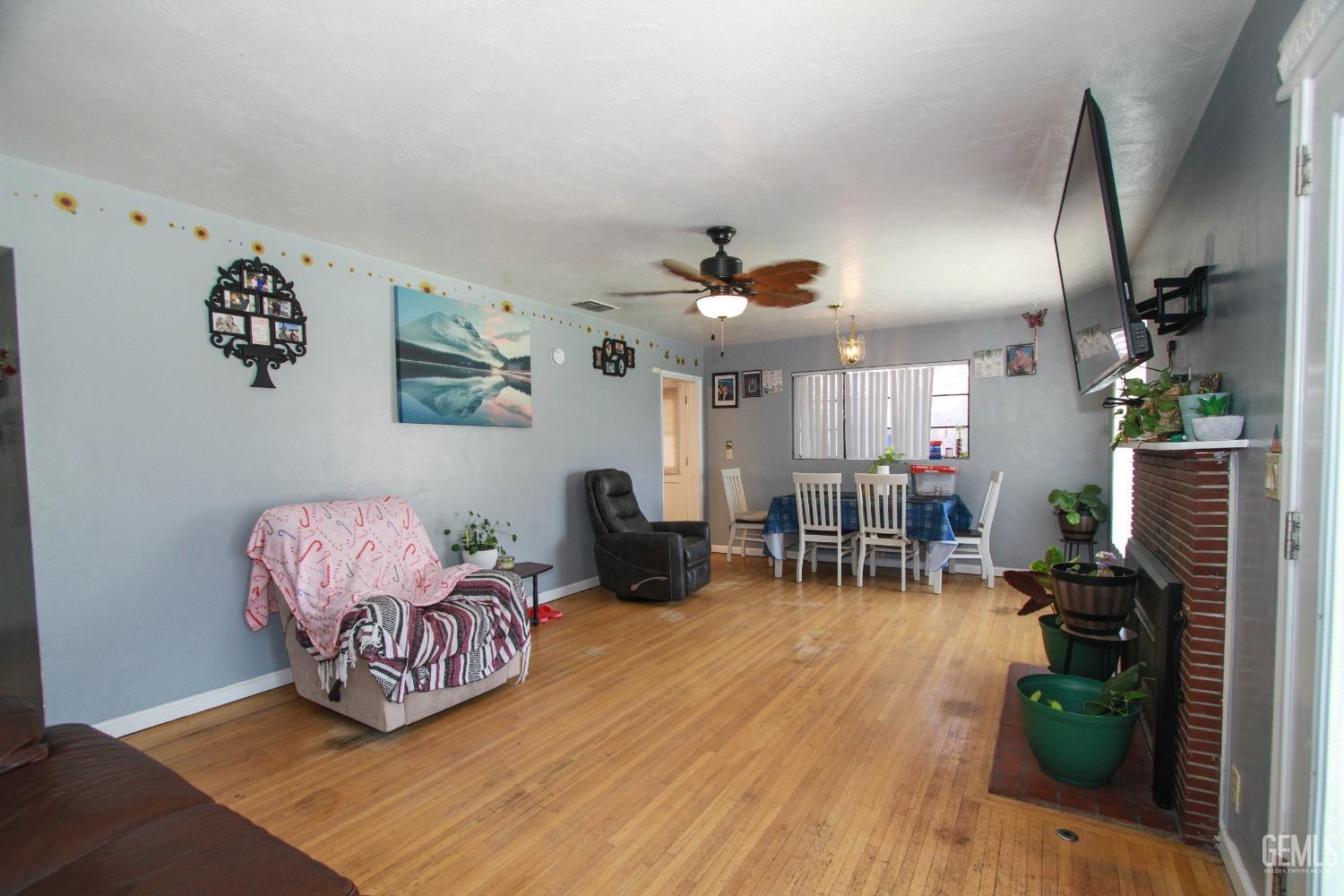Undisclosed Address Bakersfield, CA 93309 - Photo 6 of 19 a living room with furniture and wooden floor