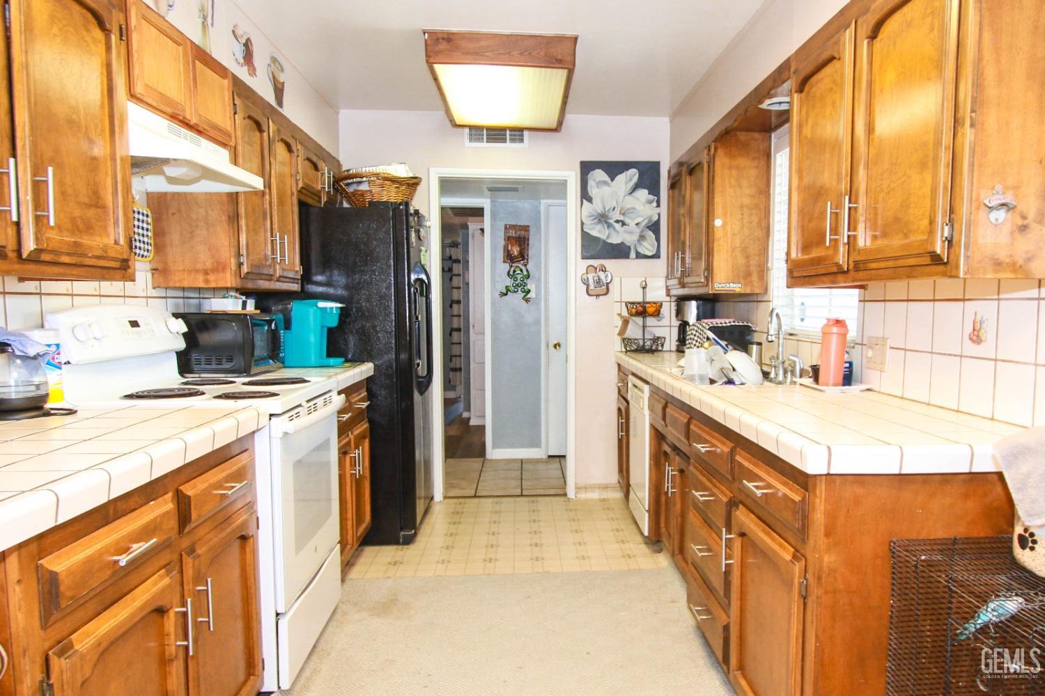 Undisclosed Address Bakersfield, CA 93309 - Photo 9 of 19 a kitchen with stainless steel appliances a sink stove and a refrigerator