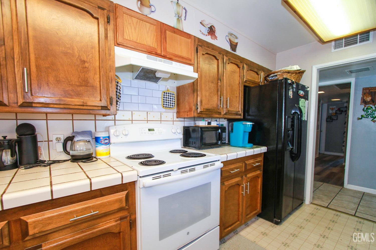 Undisclosed Address Bakersfield, CA 93309 - Photo 10 of 19 a kitchen with stainless steel appliances granite countertop a stove a sink and a refrigerator