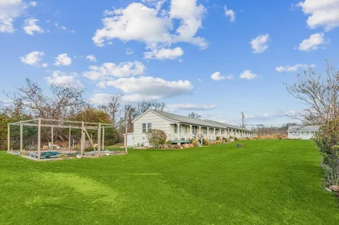 a front view of house with yard and outdoor seating
