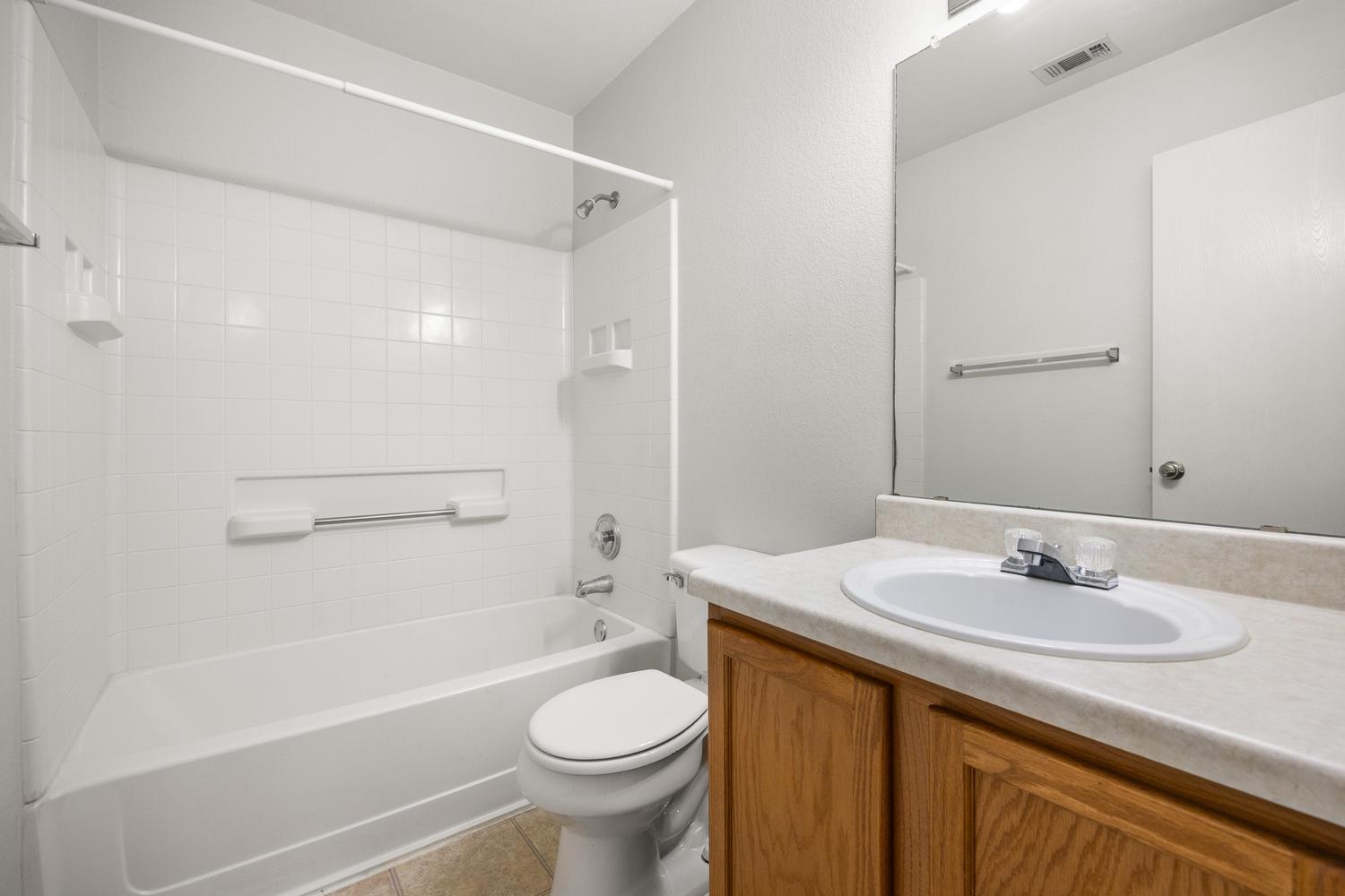 359 Spring Branch Loop Kyle, TX 78640 - Photo 11 of 17 a bathroom with a sink a toilet and a bathtub