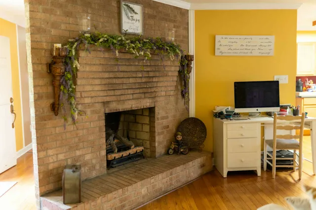 a living room with fireplace furniture and a flat screen tv