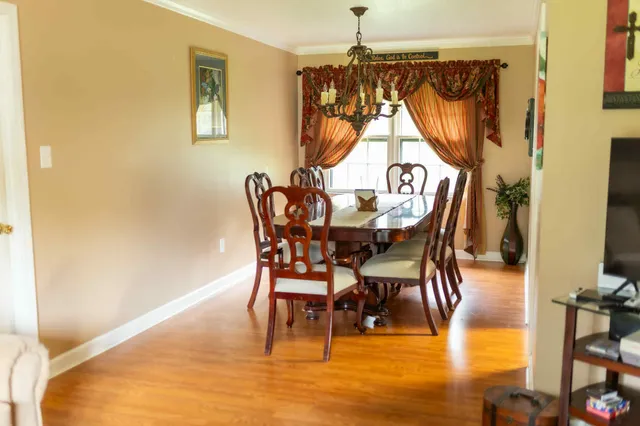 a view of a dining room with furniture and a chandelier