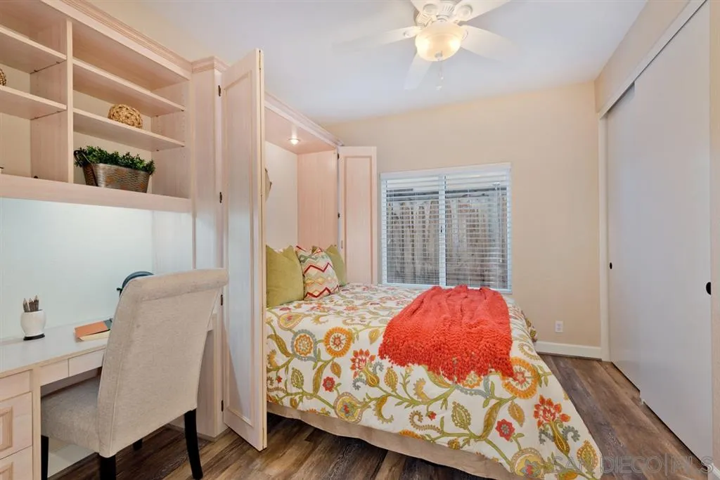 7675 Salix Place San Diego, CA 92129 - Photo 11 of 25 a bedroom with a bed and a chandelier