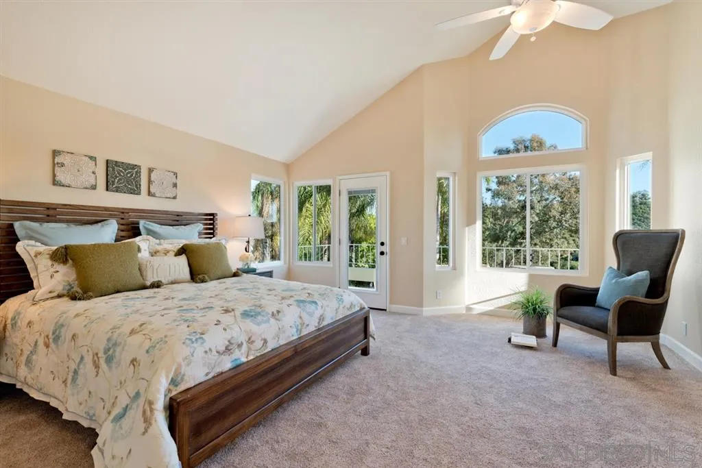 7675 Salix Place San Diego, CA 92129 - Photo 13 of 25 a spacious bedroom with a bed and a large window