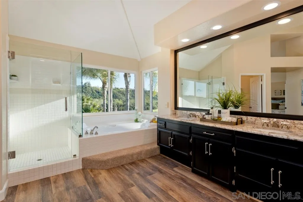 7675 Salix Place San Diego, CA 92129 - Photo 15 of 25 a spacious bathroom with a tub sink shower and mirror
