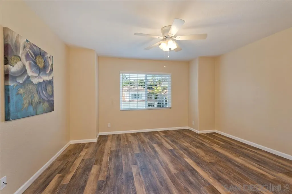 7675 Salix Place San Diego, CA 92129 - Photo 16 of 25 a view of an empty room with wooden floor and a window