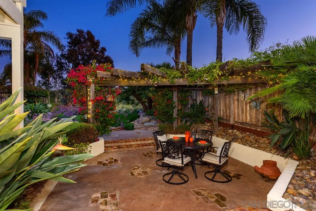 7675 Salix Place San Diego, CA 92129 - Photo 21 of 25 a view of a lake with a table and chairs in patio