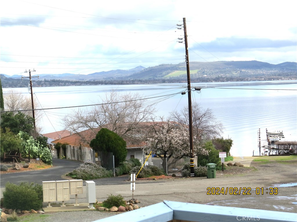 a front view of a house with a yard and lake view