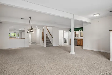 an empty room with white walls and stairs