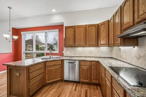 a kitchen with a sink stove and cabinets