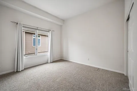 a view of an empty room and a window