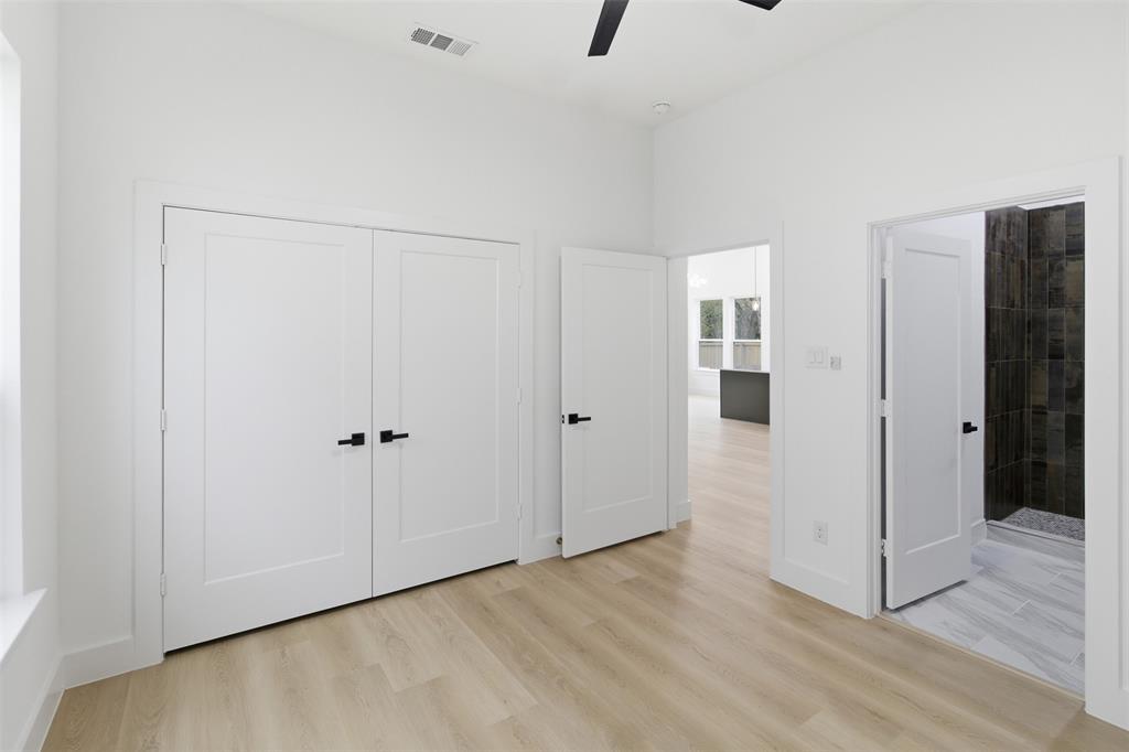 1115 Riverwood Road Dallas, TX 75217 - Photo 17 of 39 Unfurnished bedroom featuring light wood-style flooring, a ceiling fan, and a closet