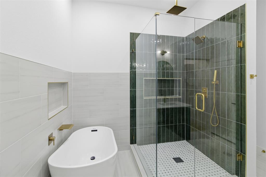 1115 Riverwood Road Dallas, TX 75217 - Photo 20 of 39 Full bathroom with a soaking tub, a stall shower, and tile walls