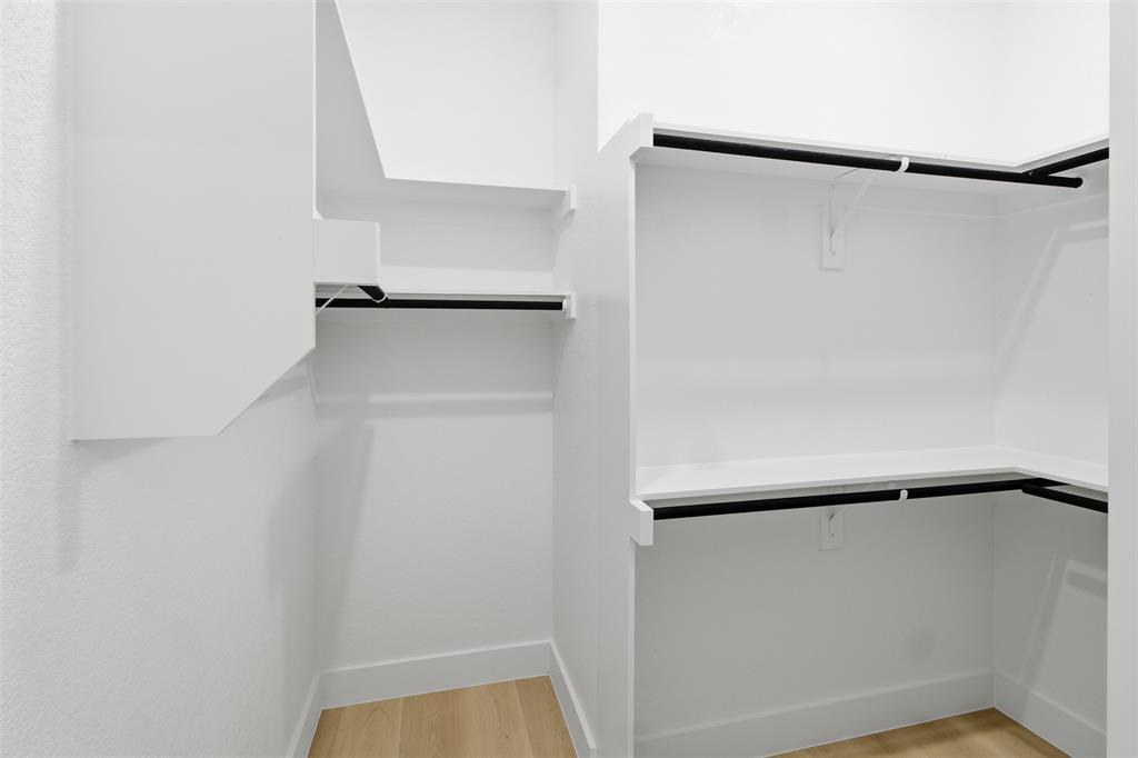 1115 Riverwood Road Dallas, TX 75217 - Photo 22 of 39 Walk in closet featuring light wood finished floors