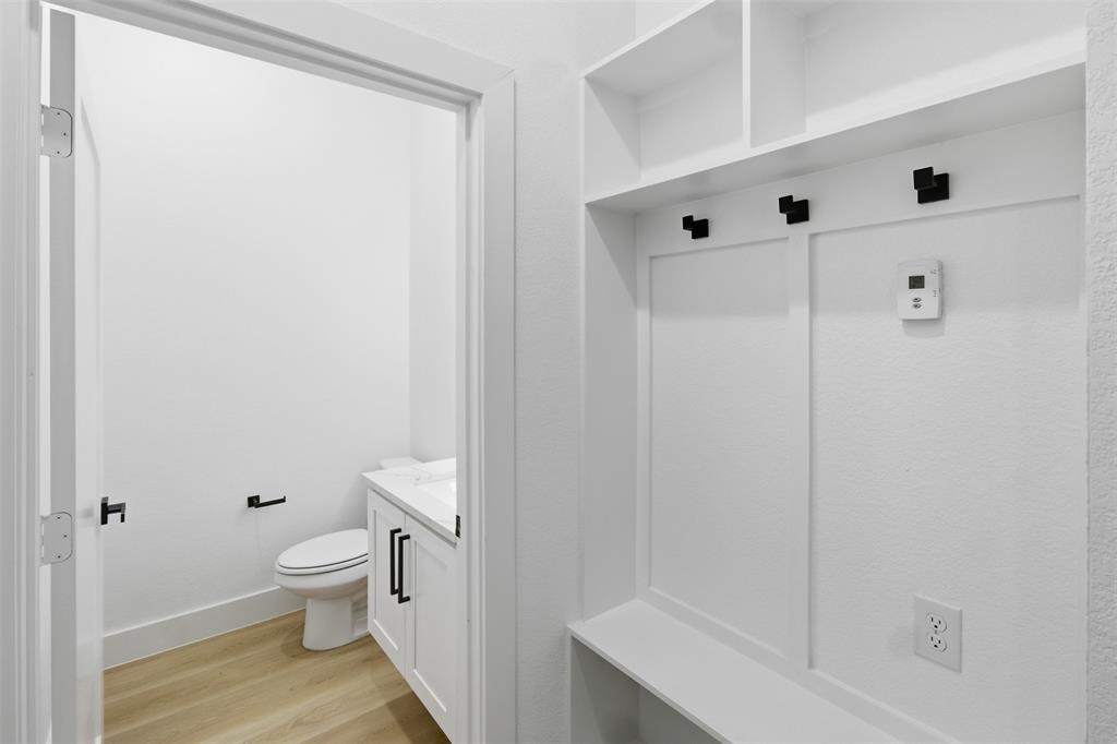 1115 Riverwood Road Dallas, TX 75217 - Photo 24 of 39 Mudroom featuring light wood-style floors and baseboards