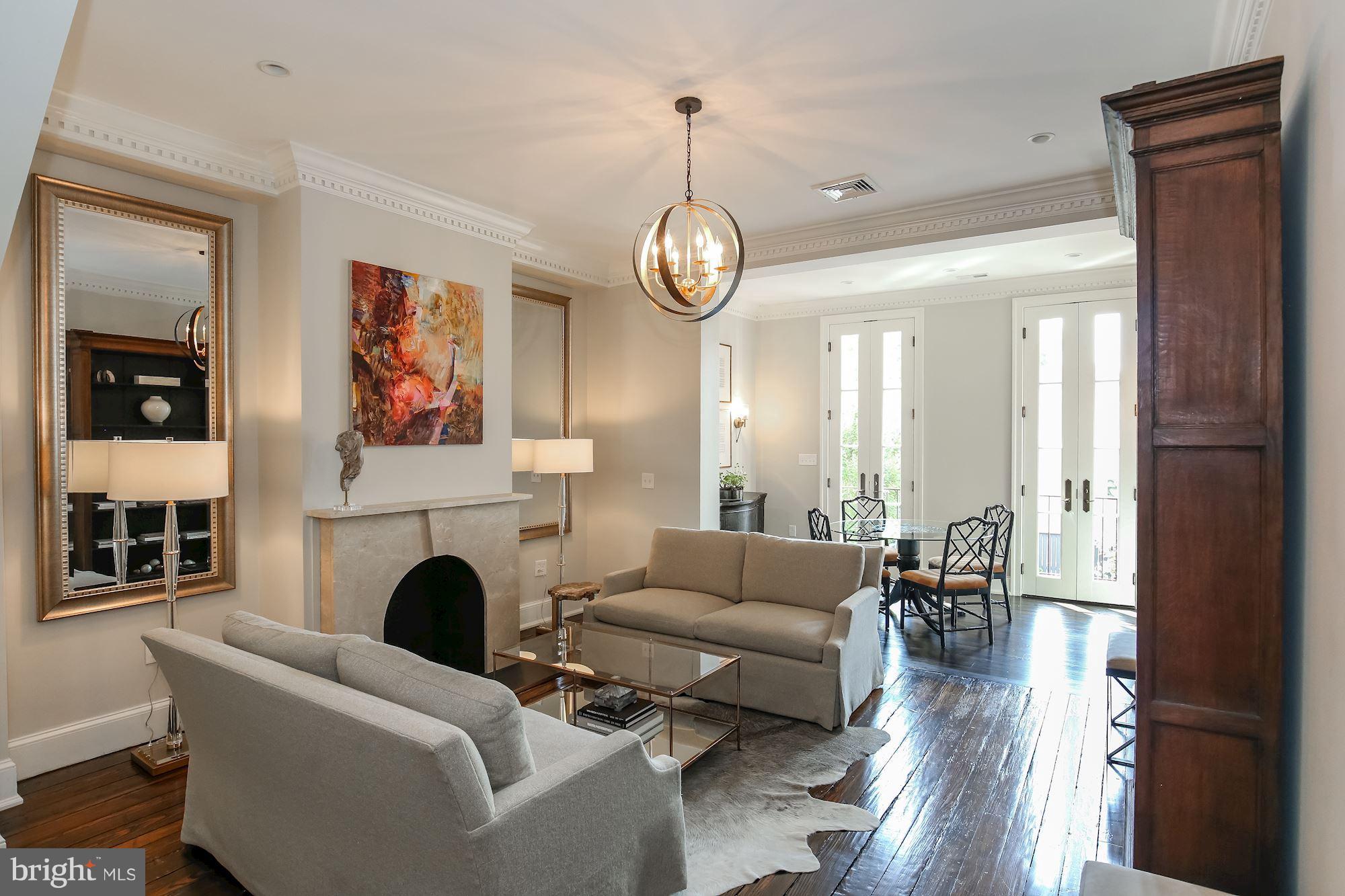 2802 P Street Northwest Washington, DC 20007 - Photo 1 of 17 a living room with furniture a fireplace and a chandelier