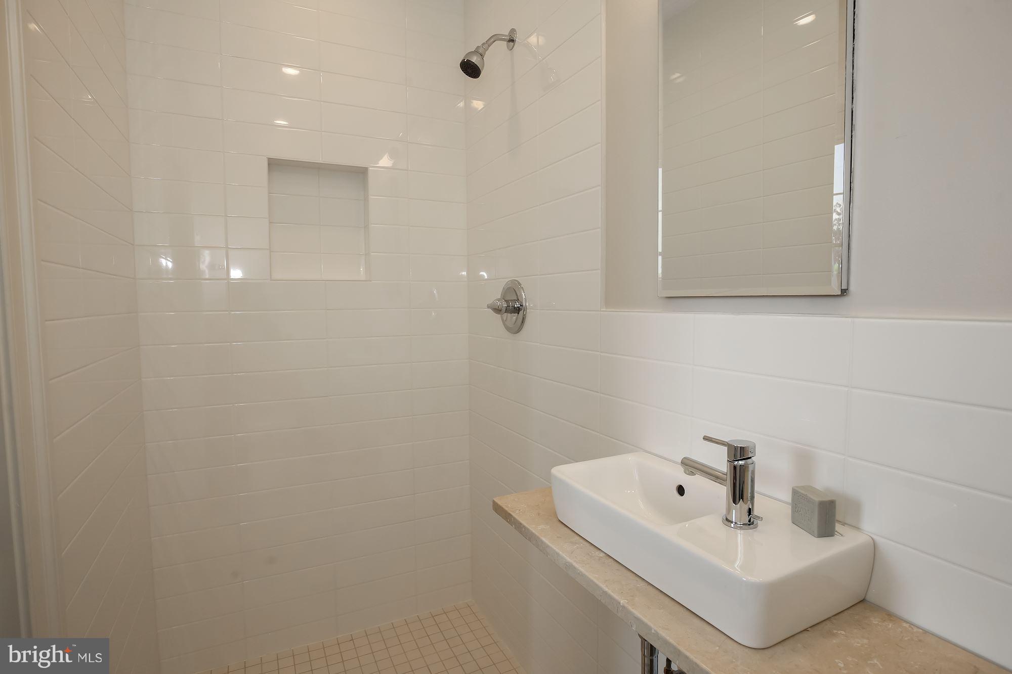 2802 P Street Northwest Washington, DC 20007 - Photo 10 of 17 a bathroom with a sink a toilet and mirror