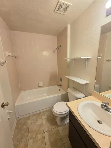 a bathroom with a sink a toilet and a bathtub