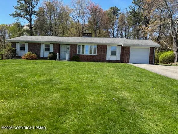 a house that has a tree in front of it