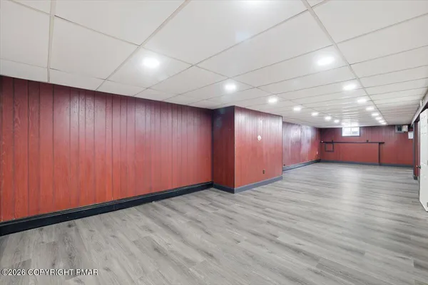 a view of an empty room with wooden walls
