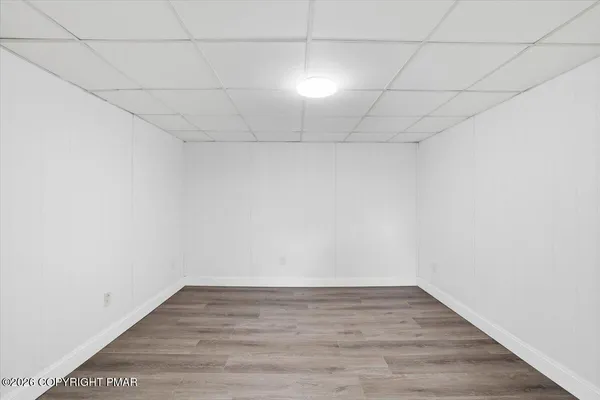 a view of empty room with wooden floor