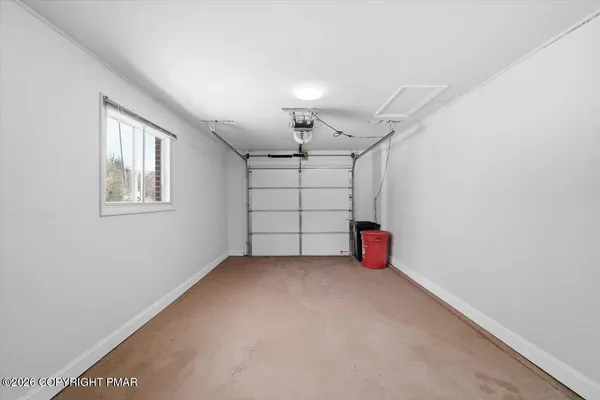 a view of a house with a yard and large tree
