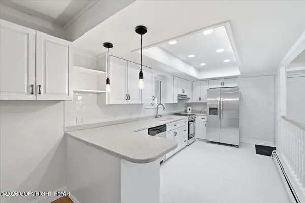 a kitchen with granite countertop white cabinets and white appliances