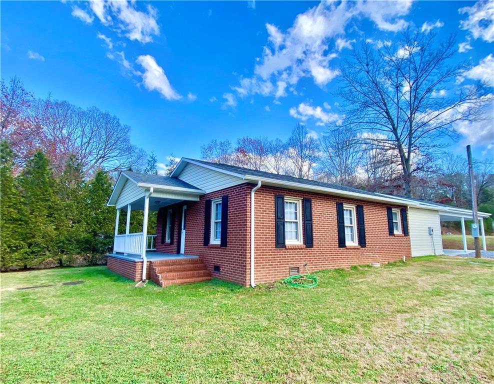 3367 Deerbrook Road Lenoir, NC 28645 - Photo 1 of 13 a front view of house with yard and trees in the background