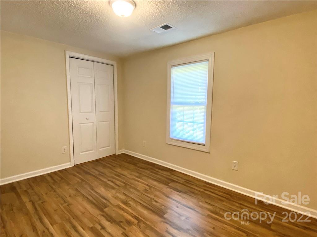 3367 Deerbrook Road Lenoir, NC 28645 - Photo 12 of 13 an empty room with wooden floor and windows
