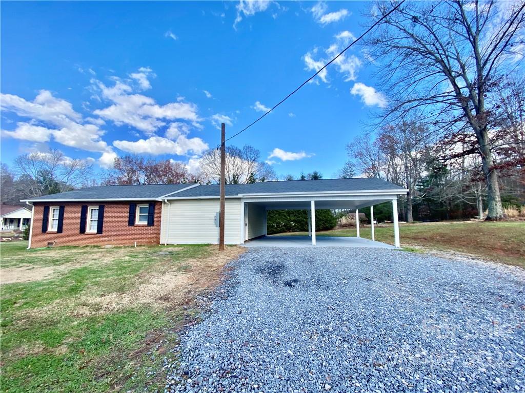 3367 Deerbrook Road Lenoir, NC 28645 - Photo 2 of 13 a front view of house with yard and trees around