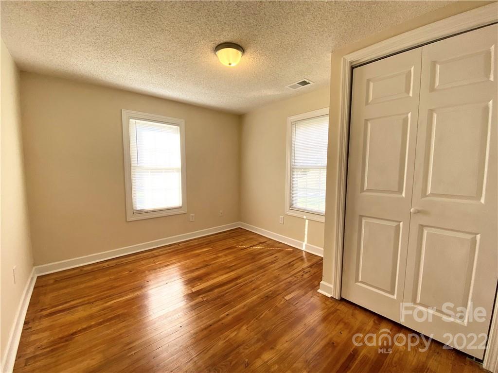 3367 Deerbrook Road Lenoir, NC 28645 - Photo 8 of 13 an empty room with wooden floor and windows