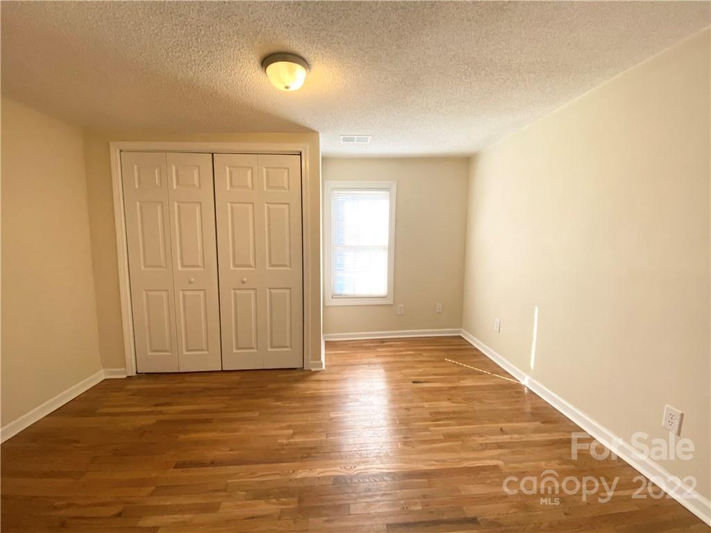 3367 Deerbrook Road Lenoir, NC 28645 - Photo 10 of 13 a view of an empty room with wooden floor