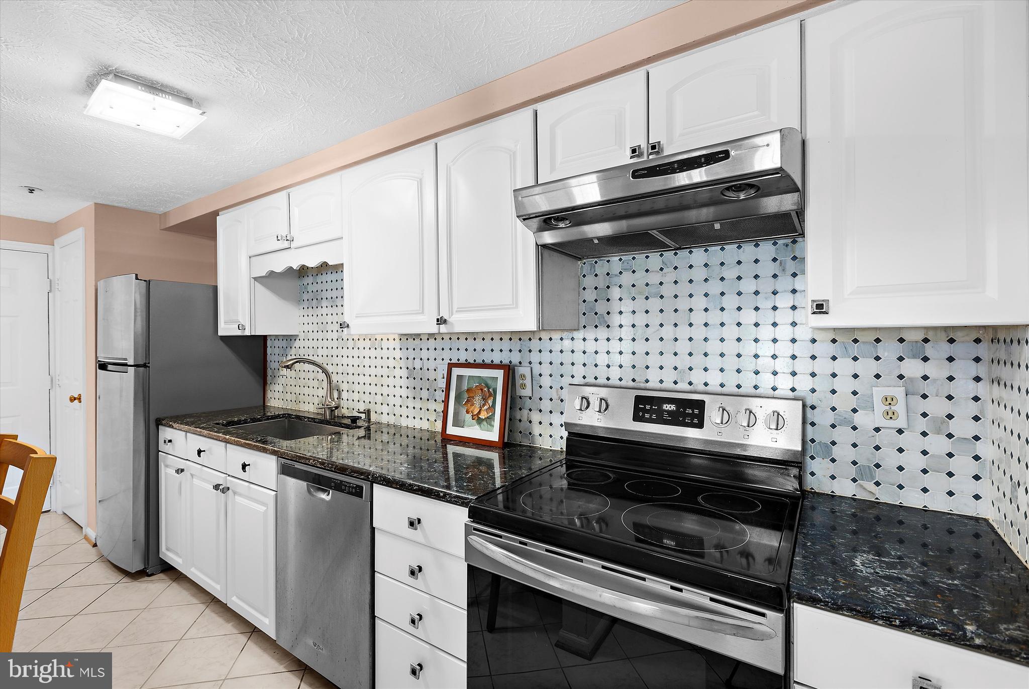 679 Deering Road, Unit 4D Pasadena, MD 21122 - Photo 11 of 28 a kitchen with stainless steel appliances a sink a stove and cabinets
