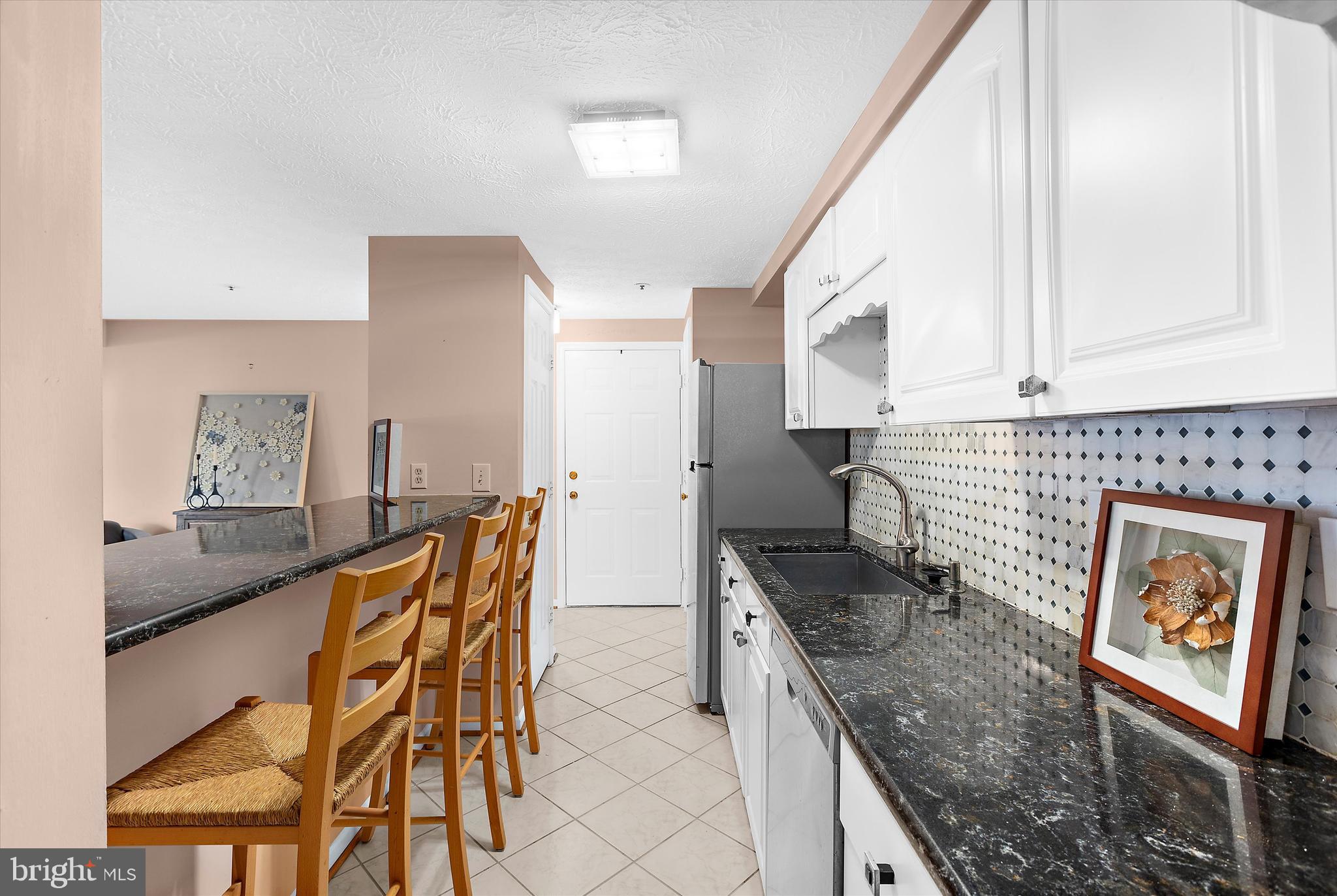 679 Deering Road, Unit 4D Pasadena, MD 21122 - Photo 12 of 28 a kitchen with stainless steel appliances granite countertop a stove a sink and a refrigerator