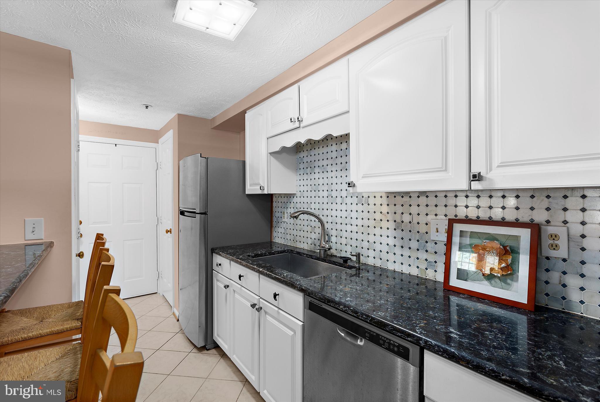 679 Deering Road, Unit 4D Pasadena, MD 21122 - Photo 13 of 28 a kitchen with stainless steel appliances granite countertop a stove a sink and a refrigerator