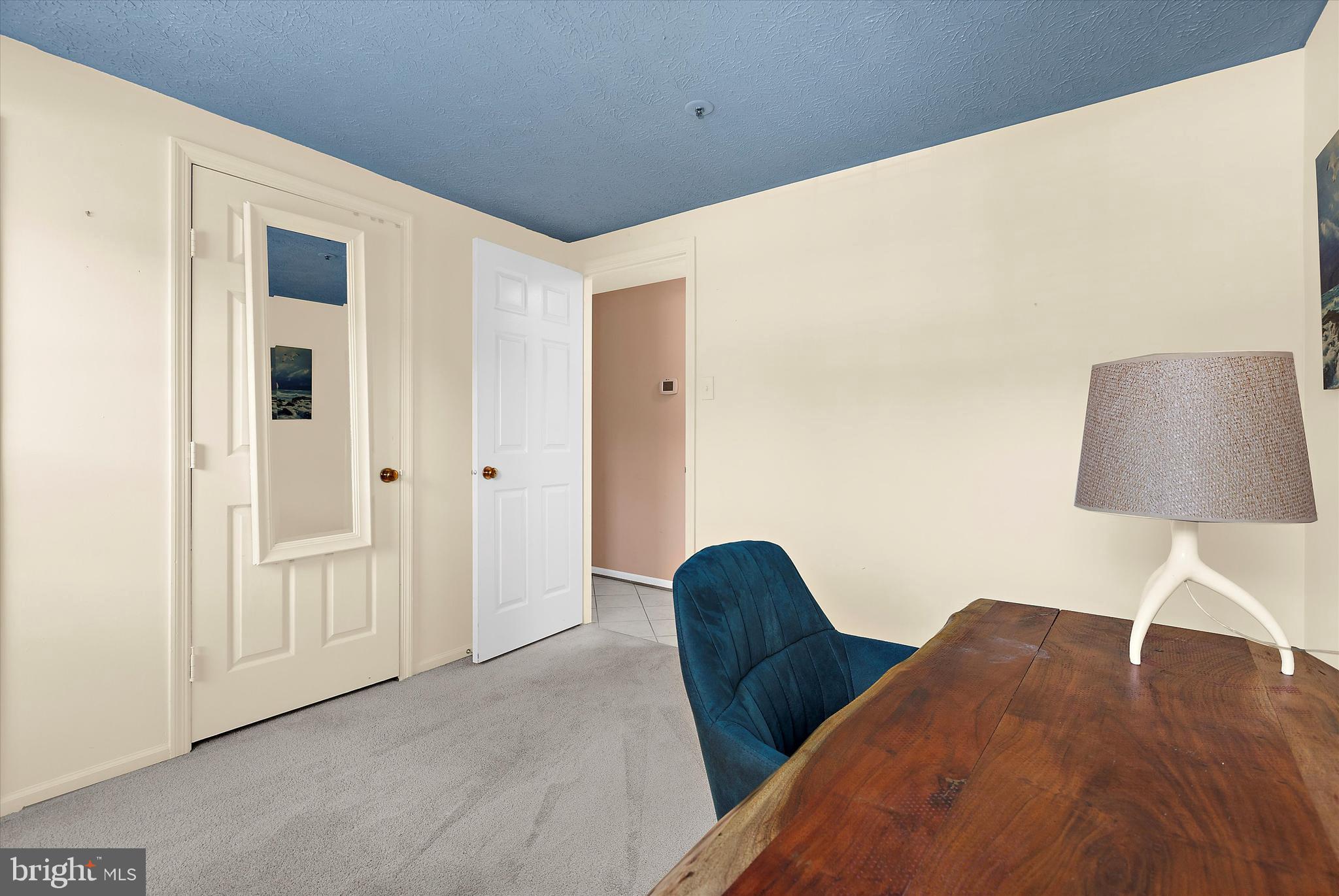 679 Deering Road, Unit 4D Pasadena, MD 21122 - Photo 15 of 28 a view of a bedroom with wooden floor and a table