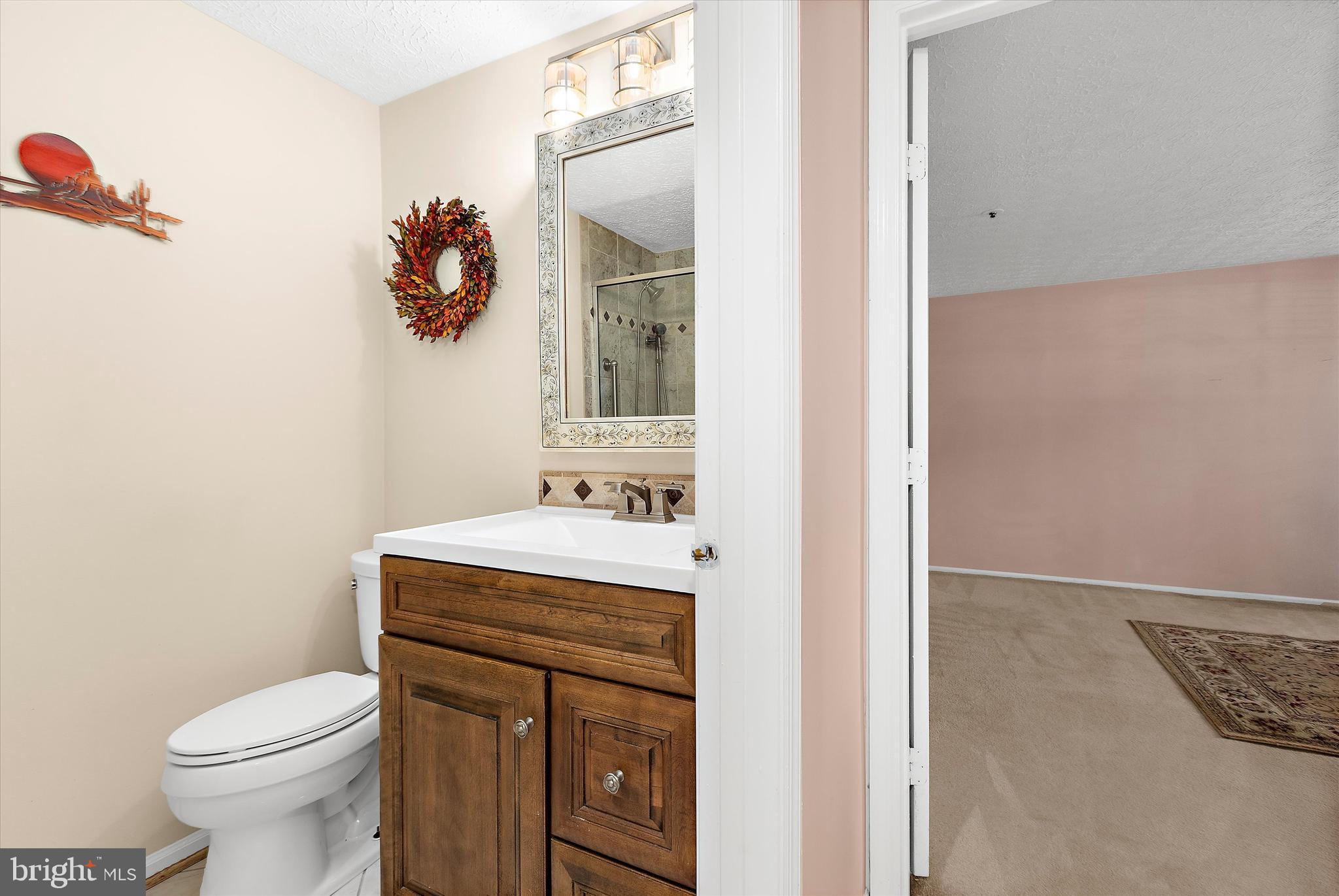 679 Deering Road, Unit 4D Pasadena, MD 21122 - Photo 20 of 28 a bathroom with a sink toilet and mirror