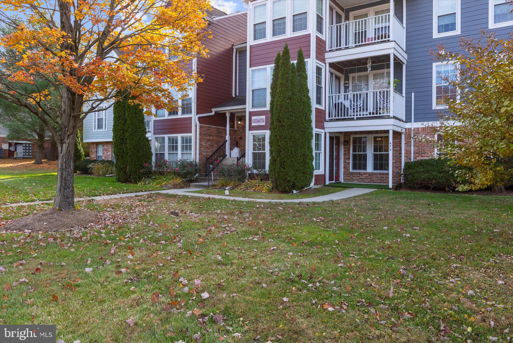 679 Deering Road, Unit 4D Pasadena, MD 21122 - Photo 26 of 28 a view of a building with a yard