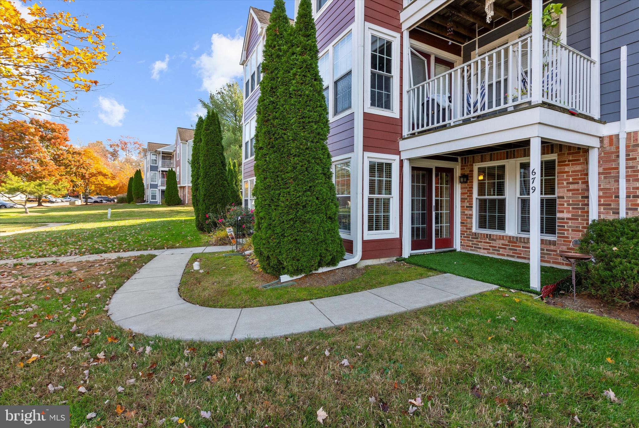 679 Deering Road, Unit 4D Pasadena, MD 21122 - Photo 27 of 28 a view of a house with a yard and plants