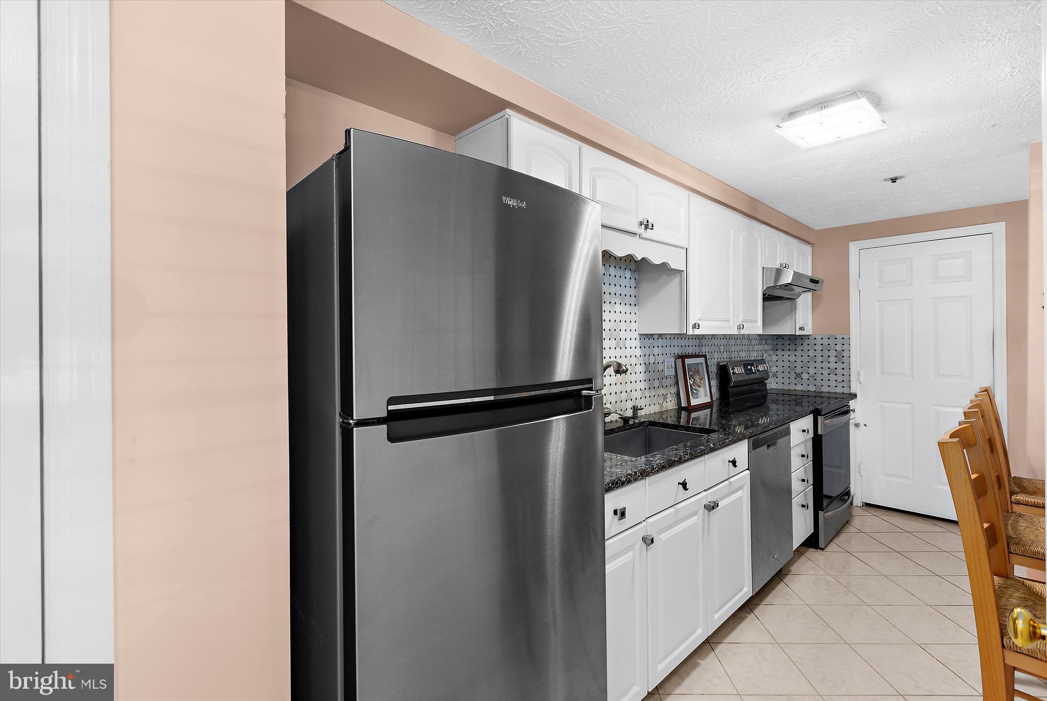 679 Deering Road, Unit 4D Pasadena, MD 21122 - Photo 9 of 28 a kitchen with stainless steel appliances a refrigerator sink and cabinets