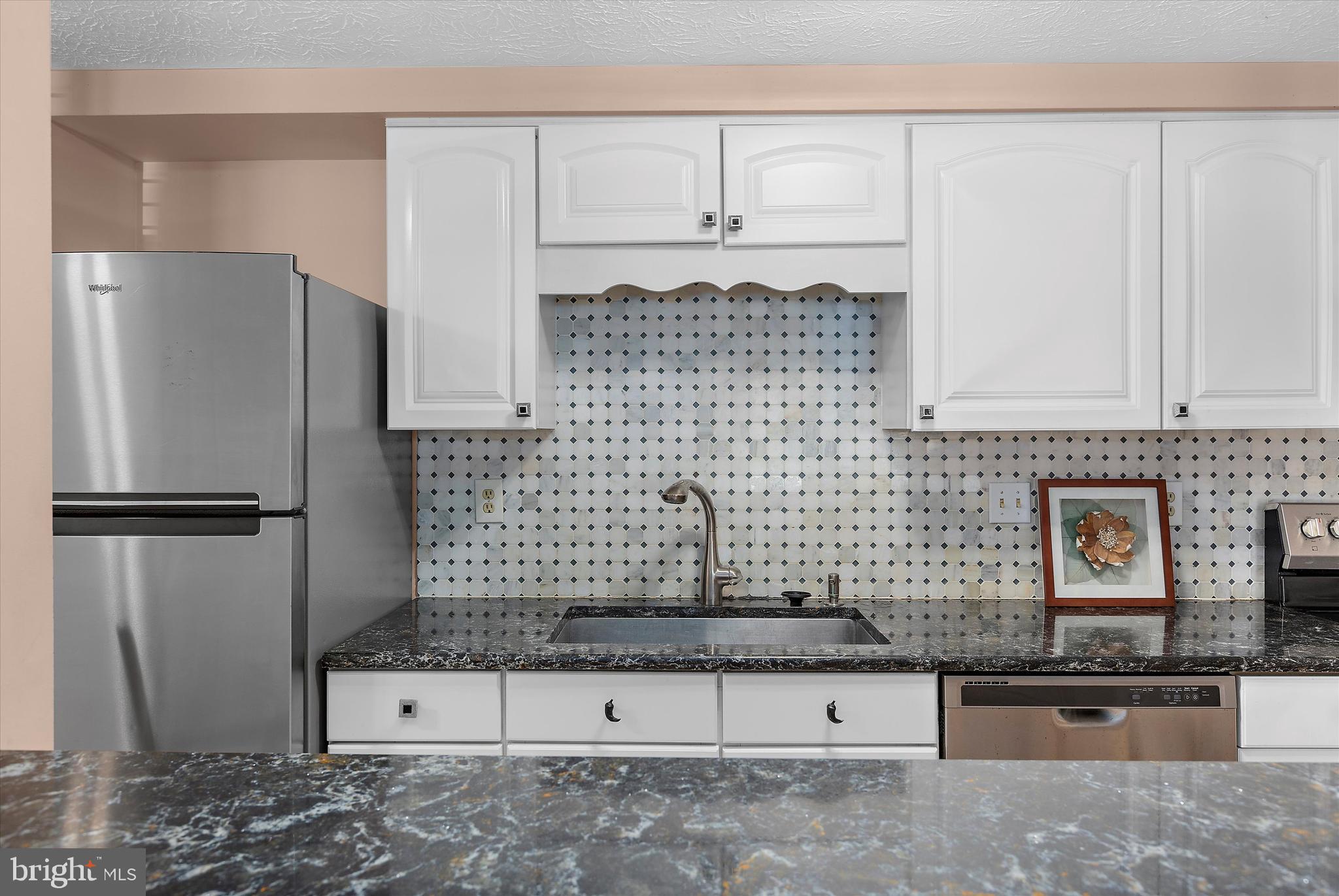 679 Deering Road, Unit 4D Pasadena, MD 21122 - Photo 10 of 28 a kitchen with stainless steel appliances granite countertop a refrigerator and a stove
