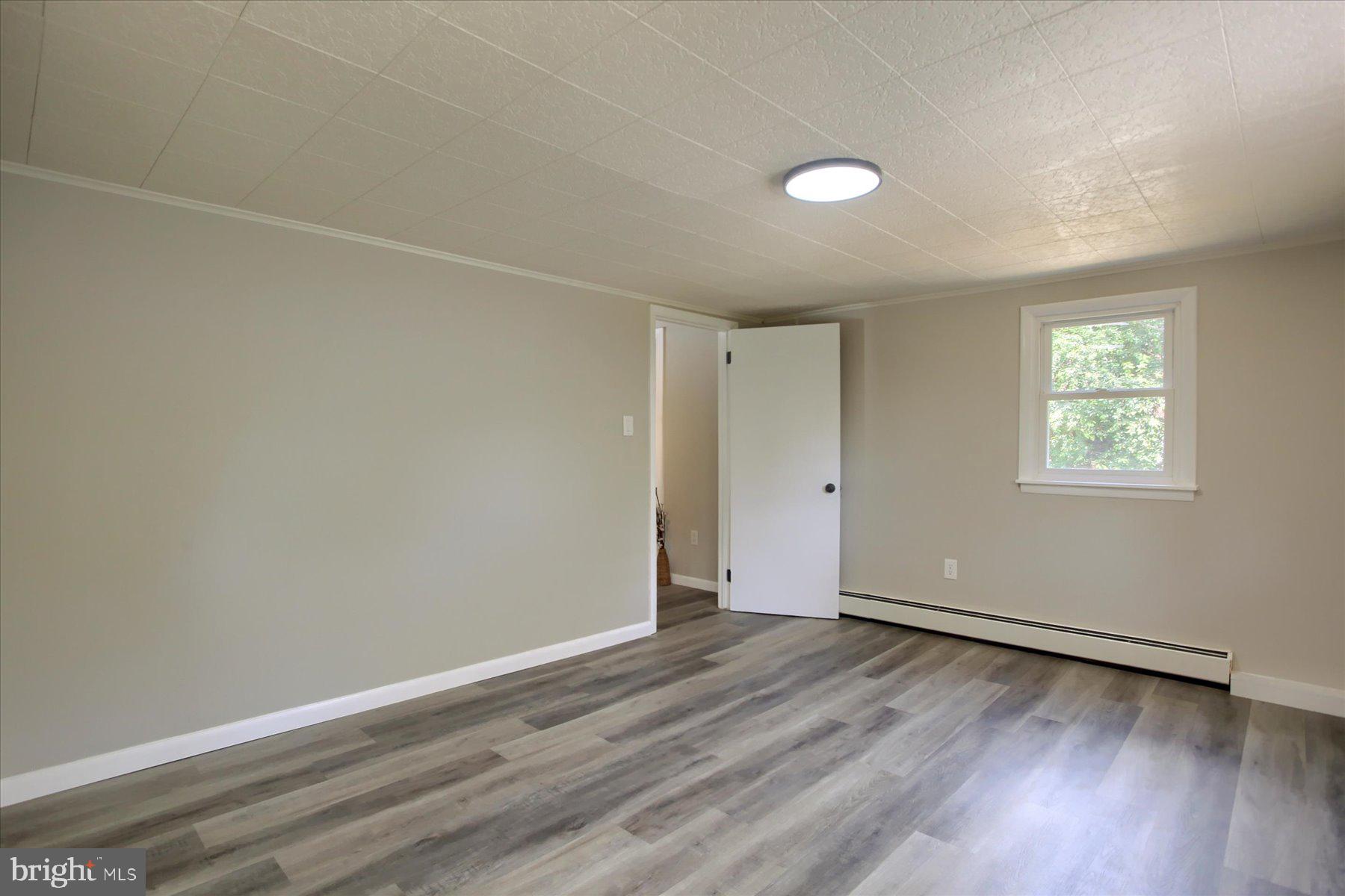 1441 Erney Road Dover, PA 17315 - Photo 20 of 45 an empty room with wooden floor and windows