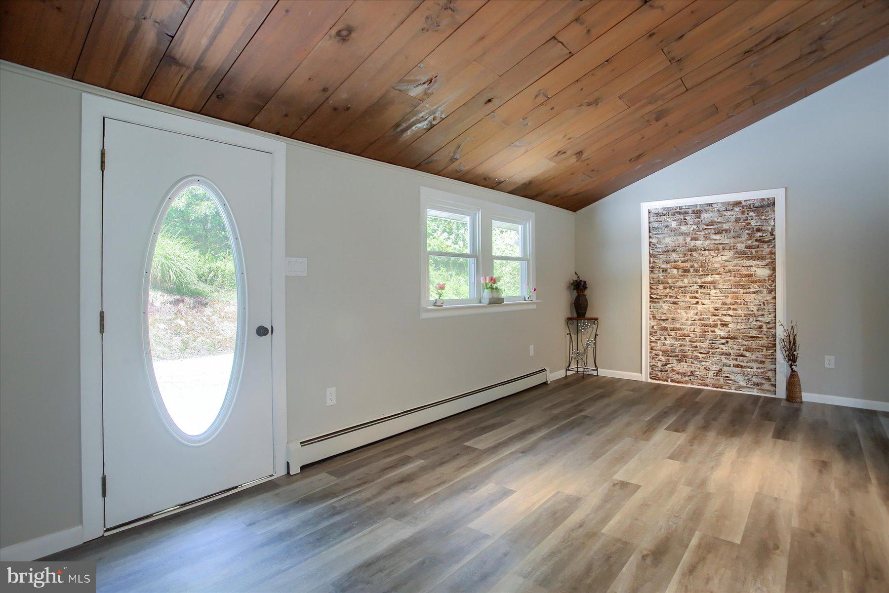 1441 Erney Road Dover, PA 17315 - Photo 6 of 45 an empty room with wooden floor and windows