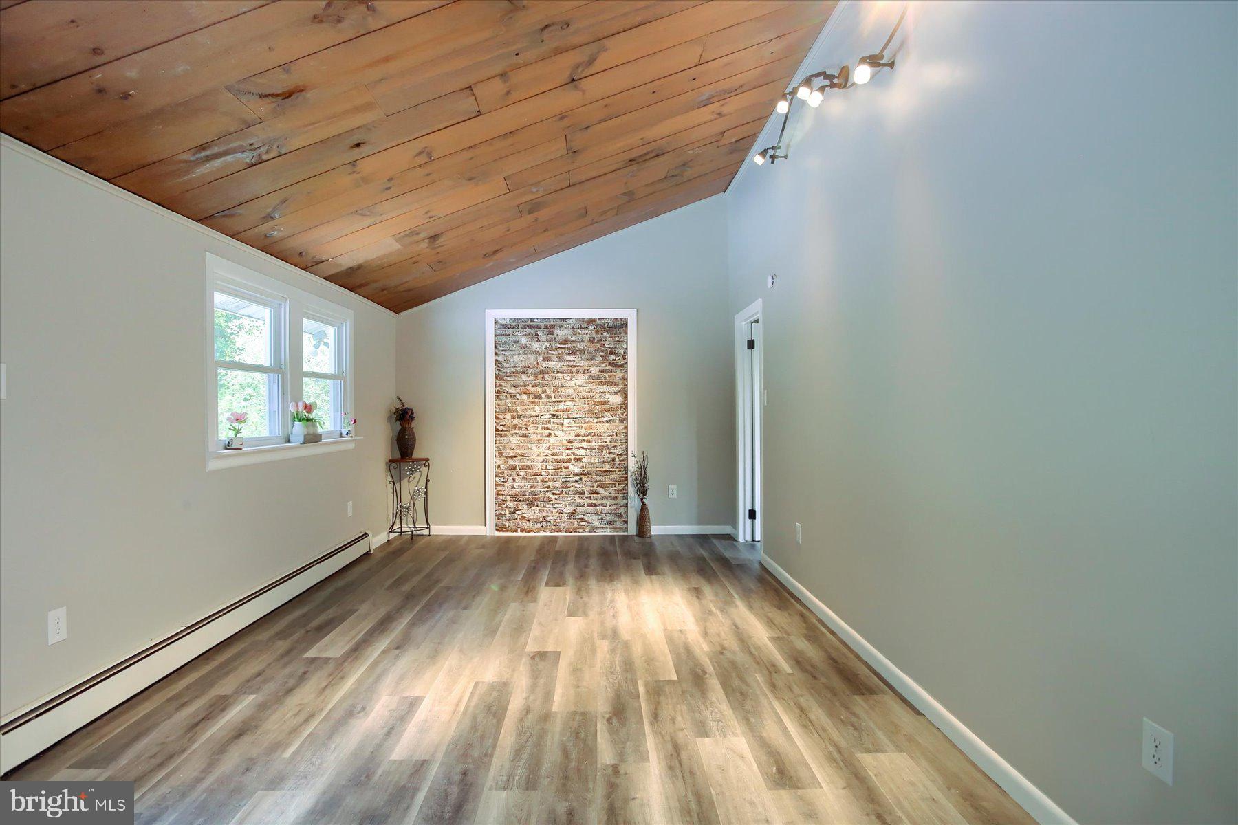 1441 Erney Road Dover, PA 17315 - Photo 8 of 45 a view of an empty room with wooden floor and a window