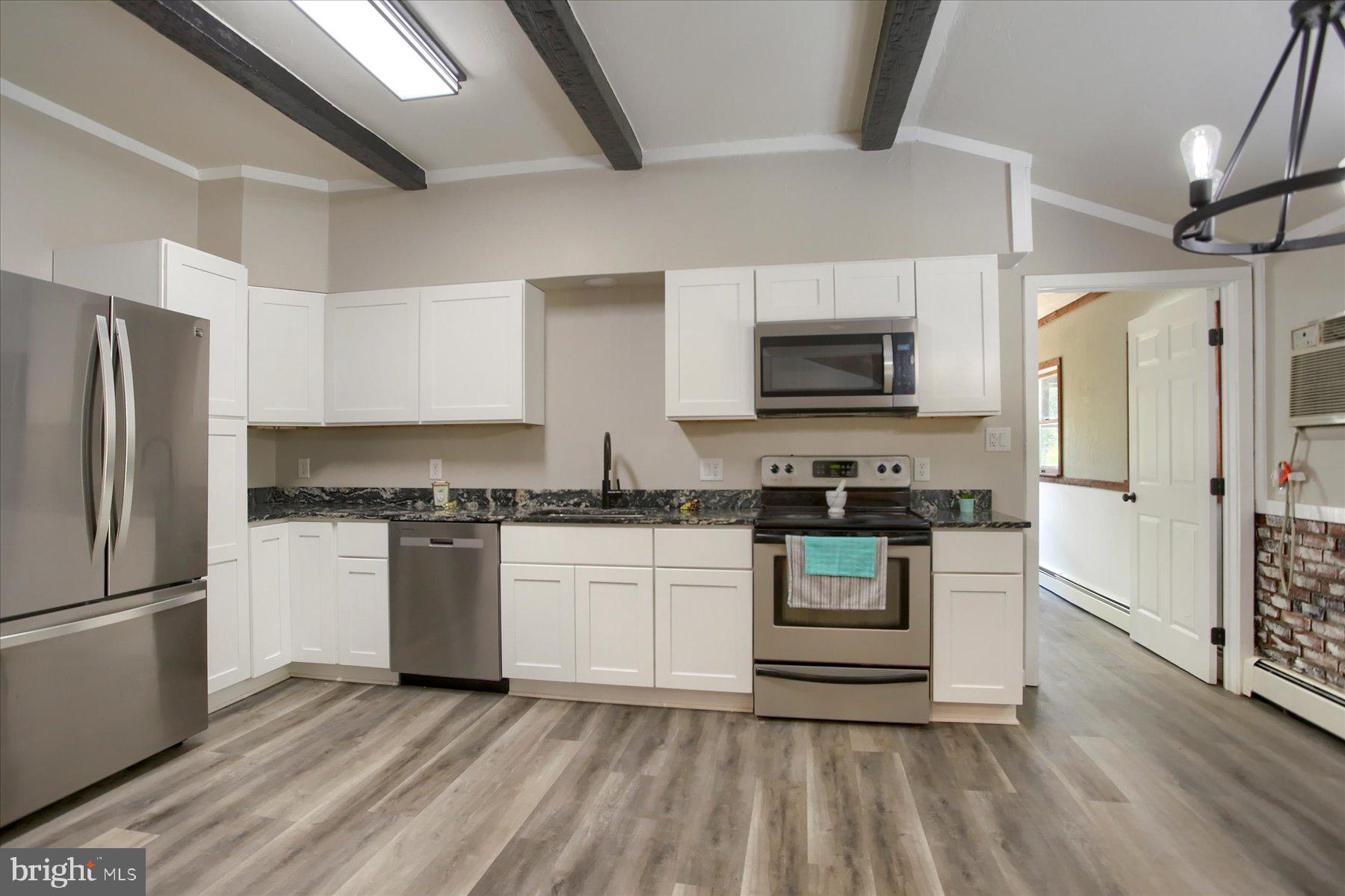 1441 Erney Road Dover, PA 17315 - Photo 9 of 45 a kitchen with stainless steel appliances granite countertop a refrigerator stove and sink