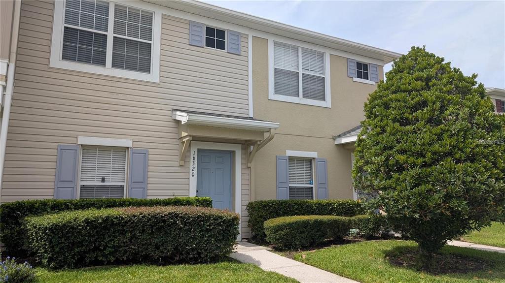 a view of a house with a yard and plants