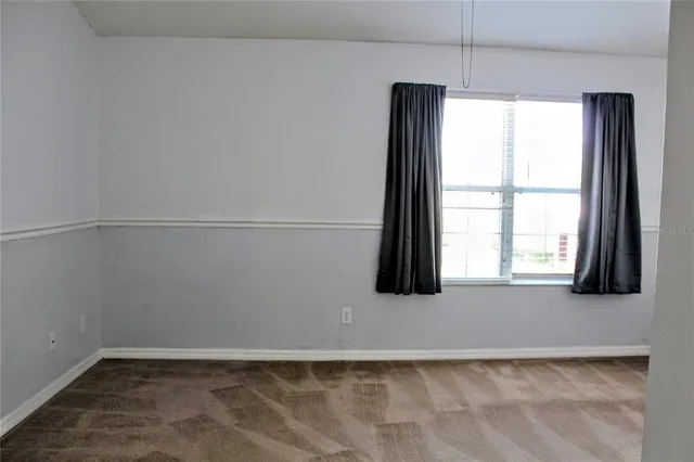 an empty room with closet and a bathroom
